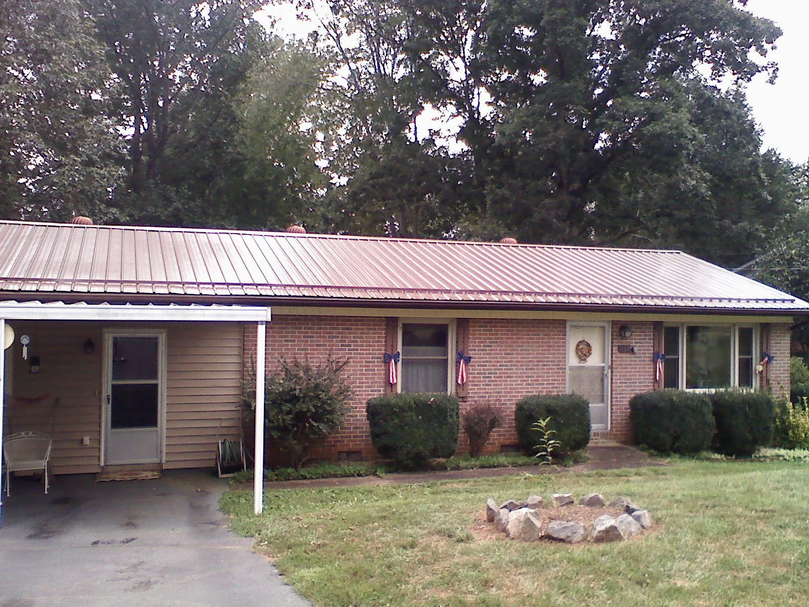 Bronze metal roof and carport on a brick ranch home in Phoenixville